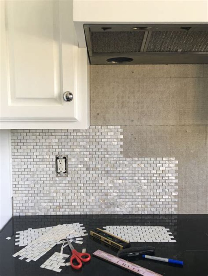 Can you put stick on backsplash over tile?