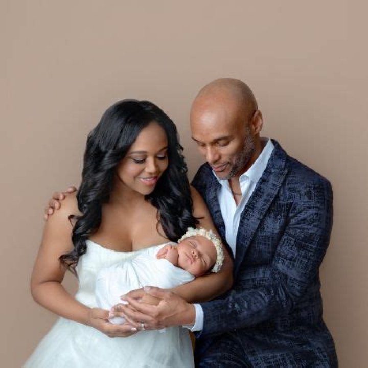 Kenny Lattimore Sr and his new wife Faith Jenkins holding their daughter Skylar.